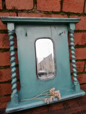 Super cute little wall mirror with hooks.